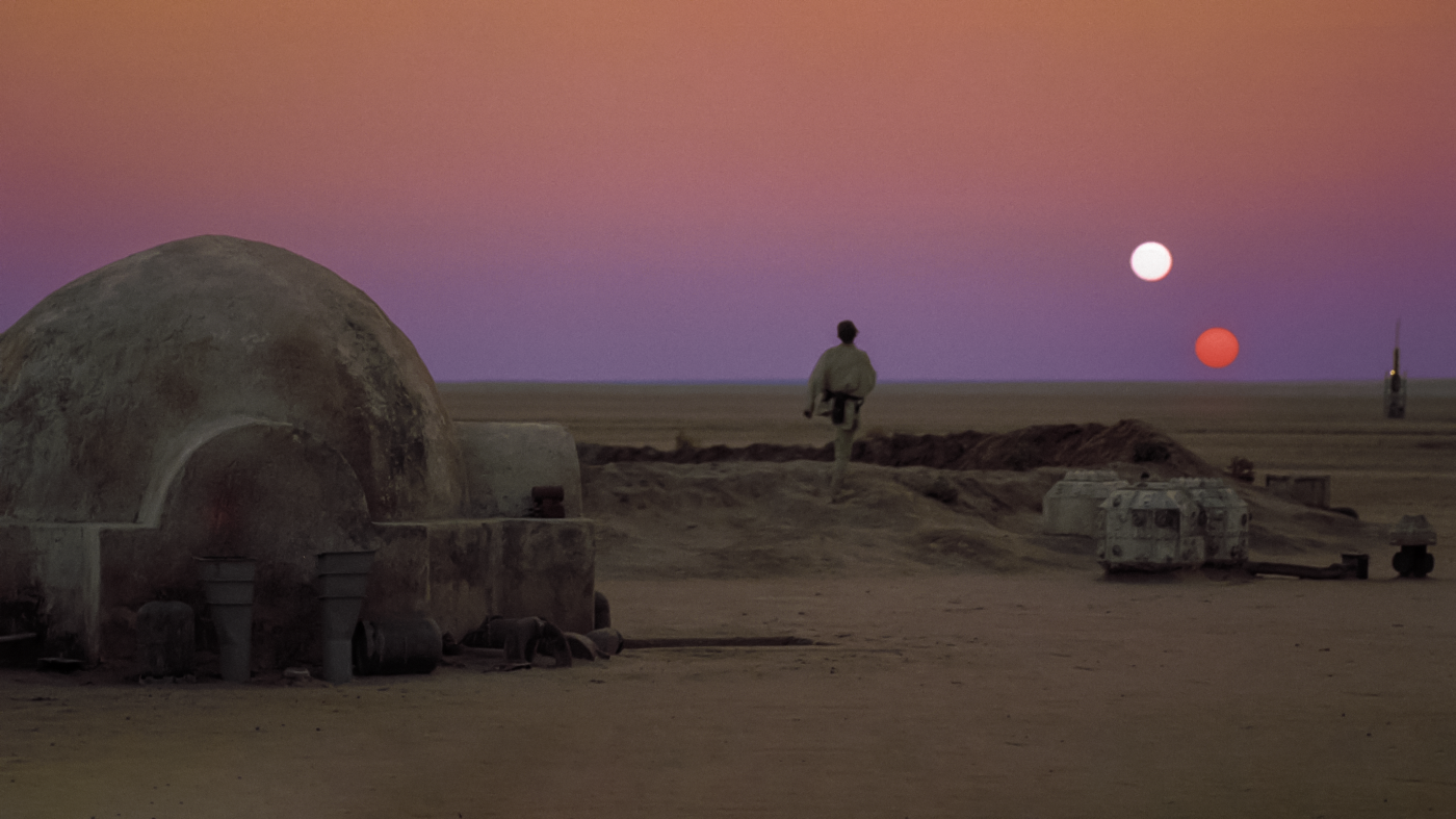 Luke Skywalker looks out at the twin suns of Tatooine in Star Wars.