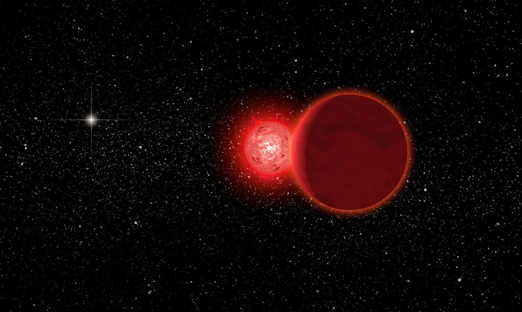 Two red dwarf stars are shown in front of a background of stars.